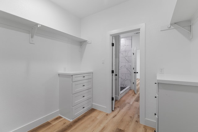 spacious closet featuring light wood-type flooring