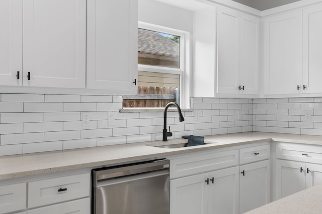 kitchen with white cabinetry, dishwasher, and sink