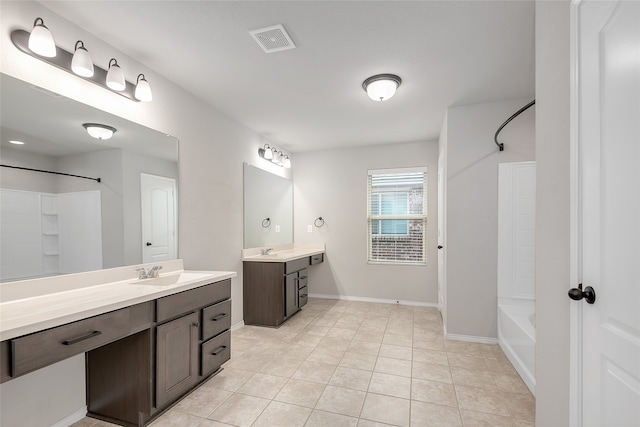 bathroom featuring tile patterned floors, vanity, and tub / shower combination