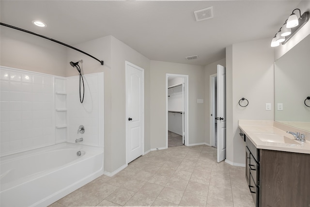 bathroom featuring tile patterned flooring, vanity, and shower / bathtub combination