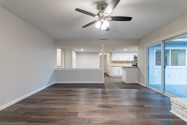 unfurnished living room featuring dark hardwood / wood-style flooring and ceiling fan