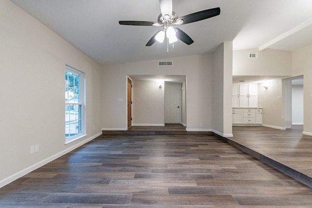 spare room with lofted ceiling with beams, ceiling fan, and dark wood-type flooring