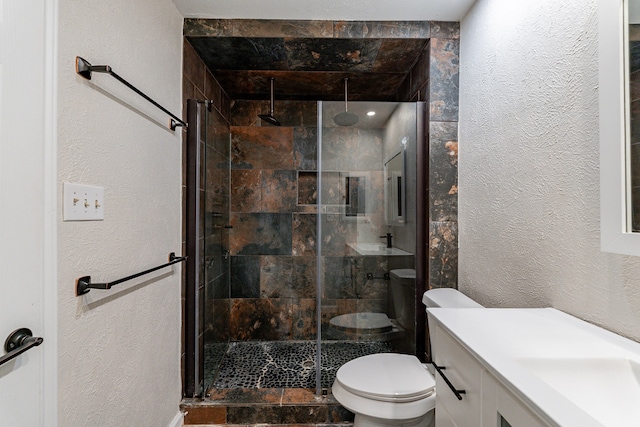 bathroom featuring an enclosed shower, vanity, and toilet