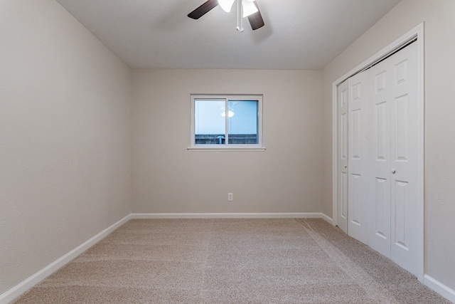 unfurnished bedroom with ceiling fan, a closet, and carpet floors