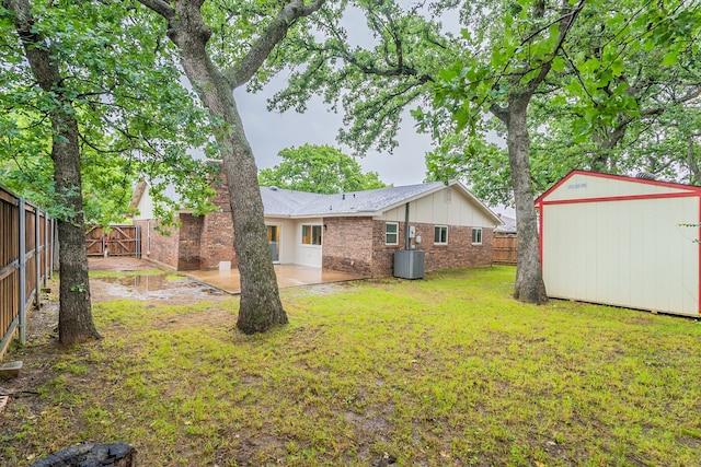 view of yard with a patio area and a storage unit