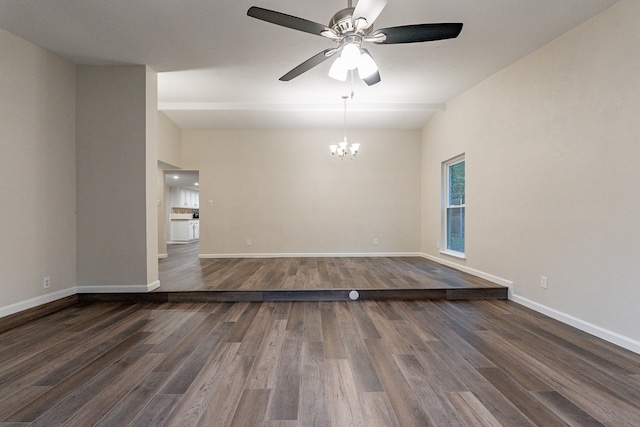 empty room featuring dark wood-type flooring and ceiling fan with notable chandelier