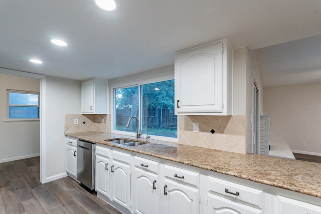 kitchen with stainless steel dishwasher, white cabinetry, and sink