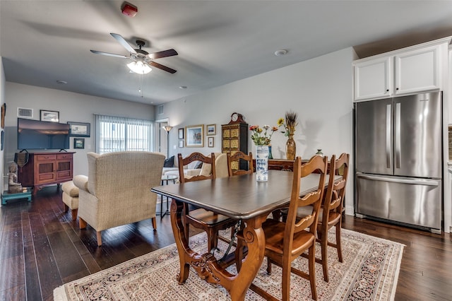 dining space with dark hardwood / wood-style floors and ceiling fan