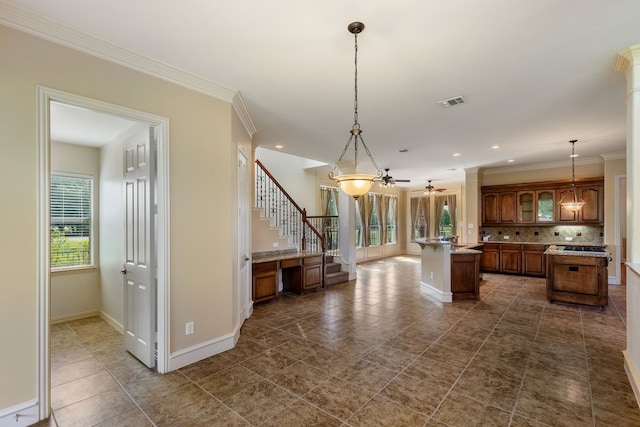 kitchen with backsplash, ceiling fan, a kitchen island, and hanging light fixtures