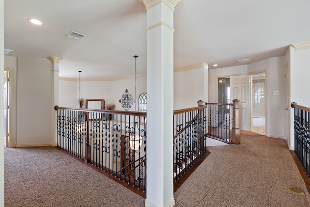 hallway with carpet floors, crown molding, and a notable chandelier