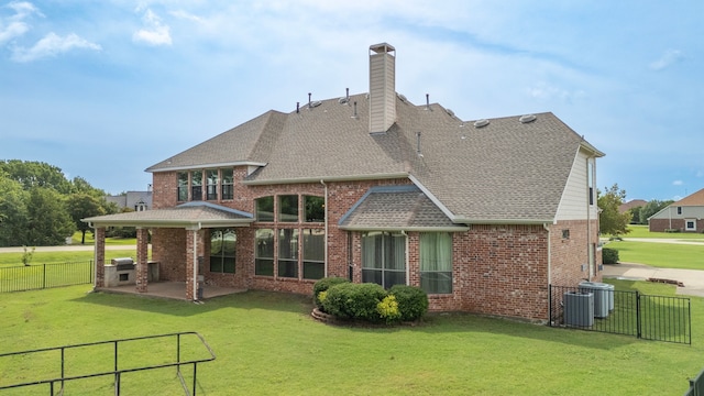 rear view of property with a patio area, a yard, and cooling unit