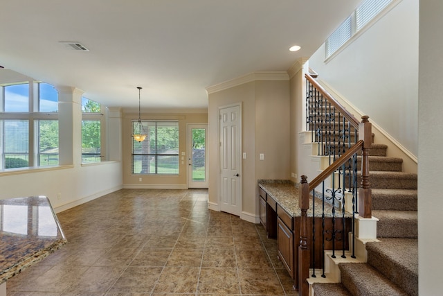 interior space featuring a healthy amount of sunlight and crown molding