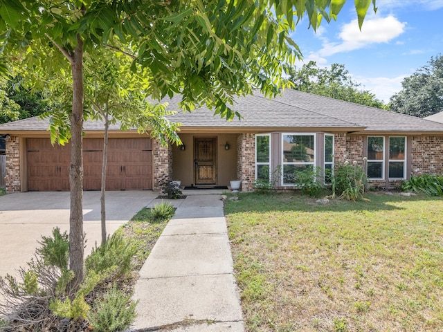 ranch-style home with a garage and a front lawn