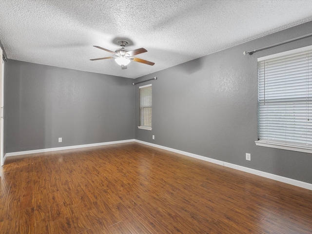 spare room with hardwood / wood-style flooring, ceiling fan, and a textured ceiling