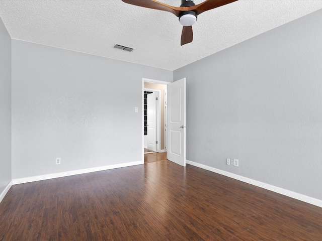 unfurnished room featuring ceiling fan, dark hardwood / wood-style floors, and a textured ceiling