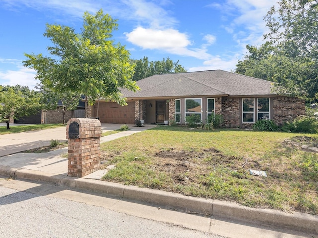 ranch-style house featuring a garage and a front lawn