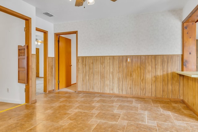 empty room with beam ceiling, wood walls, a textured ceiling, and carpet floors