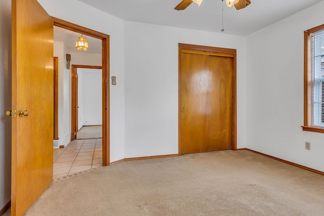 laundry room featuring ceiling fan and cabinets