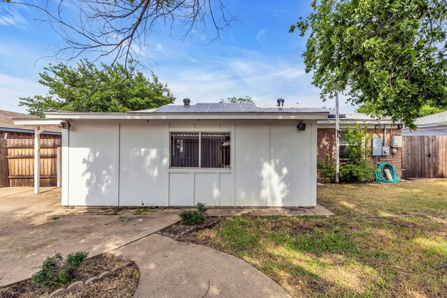 rear view of house featuring cooling unit and a yard