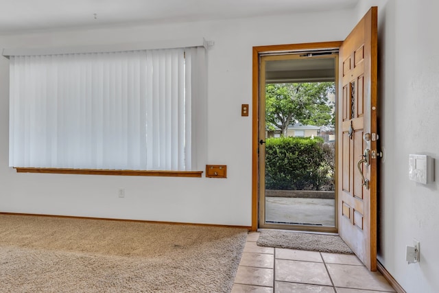 unfurnished room featuring light carpet, ceiling fan, and plenty of natural light