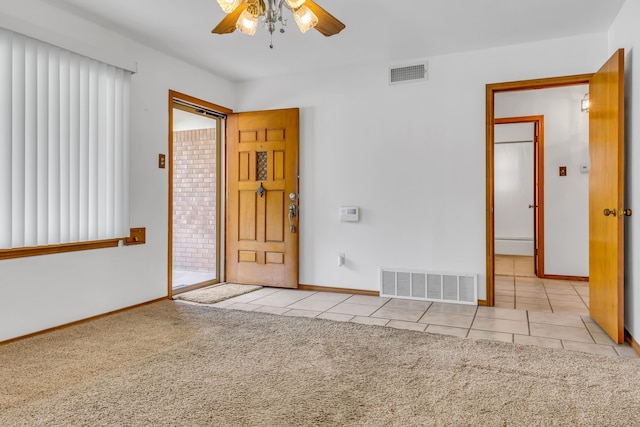 empty room with ceiling fan and carpet floors