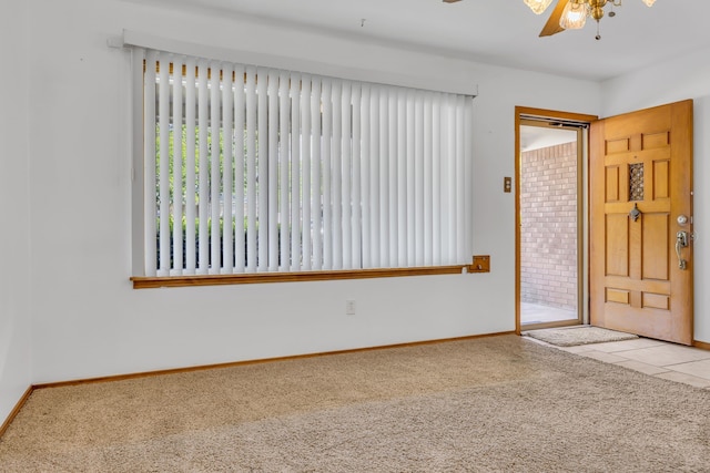 unfurnished room with ceiling fan and light colored carpet