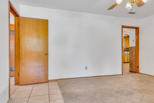 carpeted empty room featuring ceiling fan