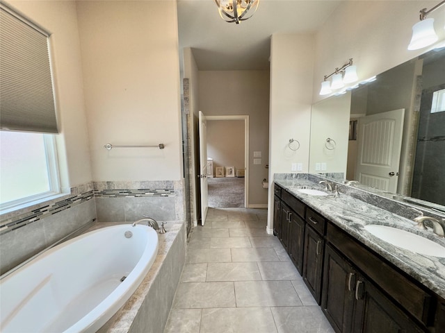 full bathroom featuring a garden tub, tile patterned floors, a sink, and double vanity