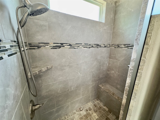 bathroom featuring a tile shower