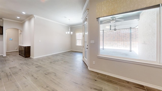 unfurnished room featuring ceiling fan with notable chandelier, hardwood / wood-style floors, and ornamental molding