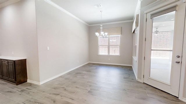 unfurnished dining area with an inviting chandelier, ornamental molding, and light hardwood / wood-style flooring