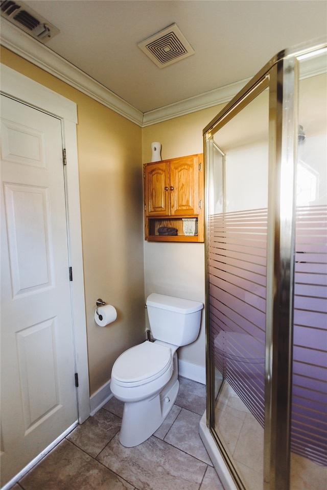 bathroom with tile patterned flooring, toilet, an enclosed shower, and crown molding