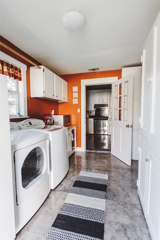 laundry room with cabinets and separate washer and dryer