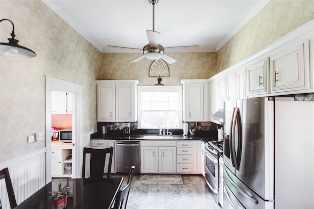 kitchen with sink, stainless steel appliances, ornamental molding, exhaust hood, and light wood-type flooring