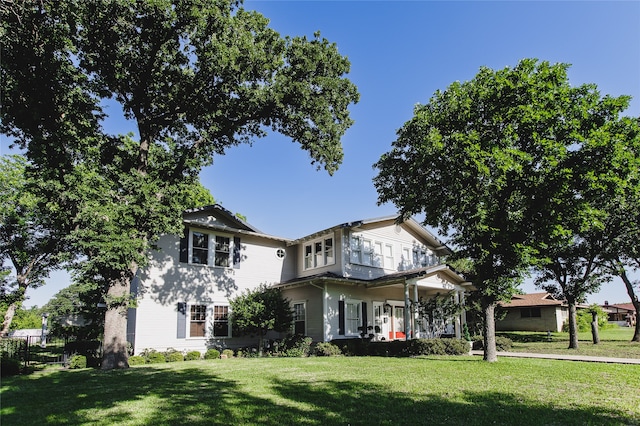 view of front facade with covered porch and a front lawn