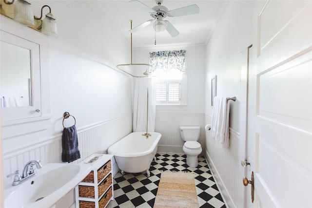 bathroom with sink, a washtub, ceiling fan, toilet, and ornamental molding