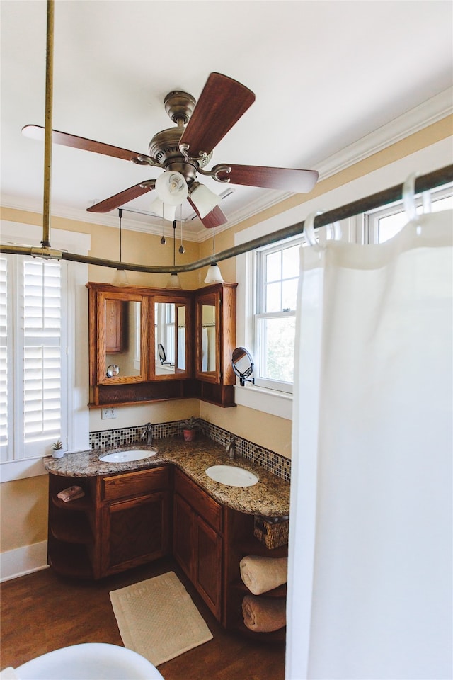 bathroom with hardwood / wood-style floors, vanity, ceiling fan, and crown molding