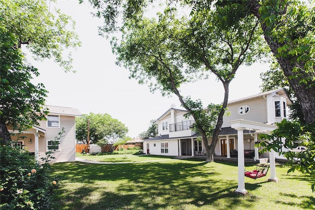 view of yard with a balcony