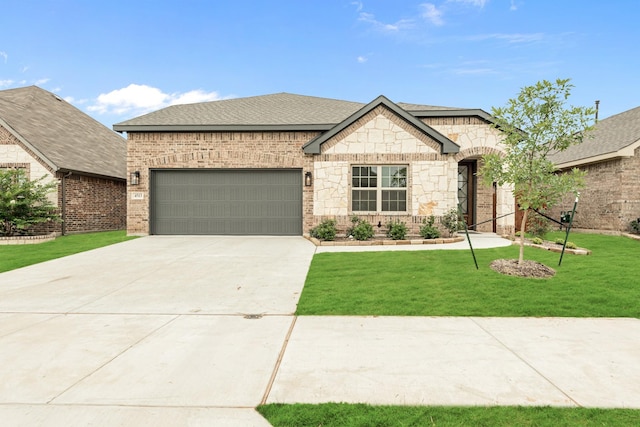 view of front of home with a front yard and a garage