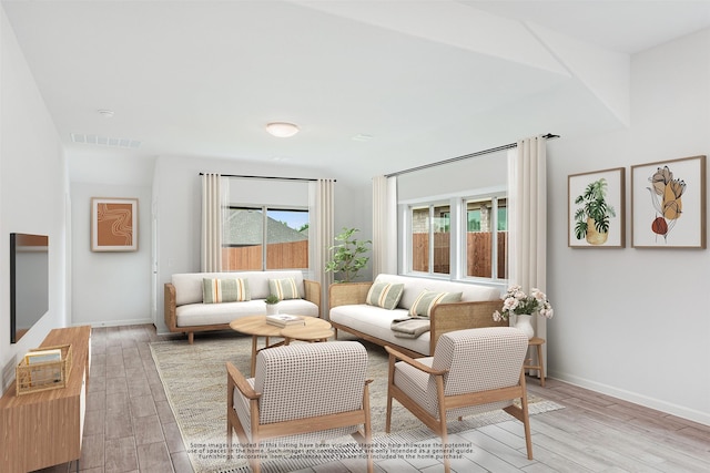 living room featuring light hardwood / wood-style floors and a wealth of natural light