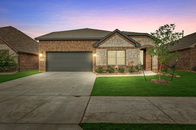 craftsman-style home featuring a yard and a garage