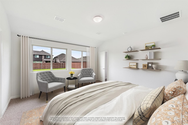 bedroom featuring carpet and lofted ceiling