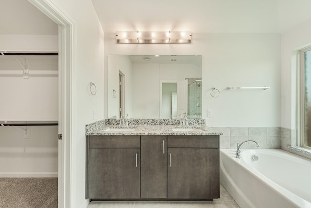 bathroom featuring vanity and shower with separate bathtub