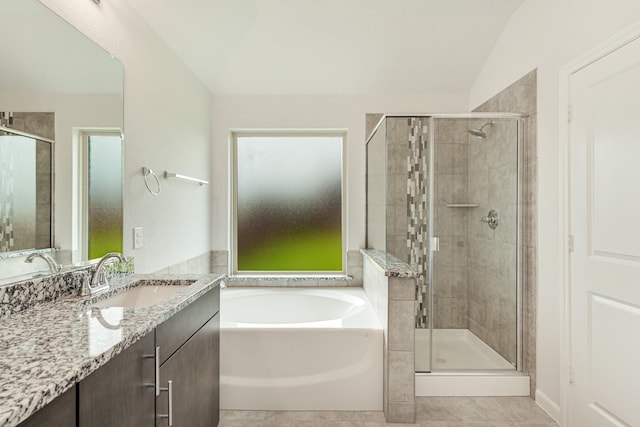 bathroom featuring vanity, tile patterned floors, separate shower and tub, and vaulted ceiling