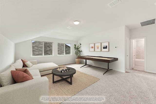 carpeted living room with vaulted ceiling