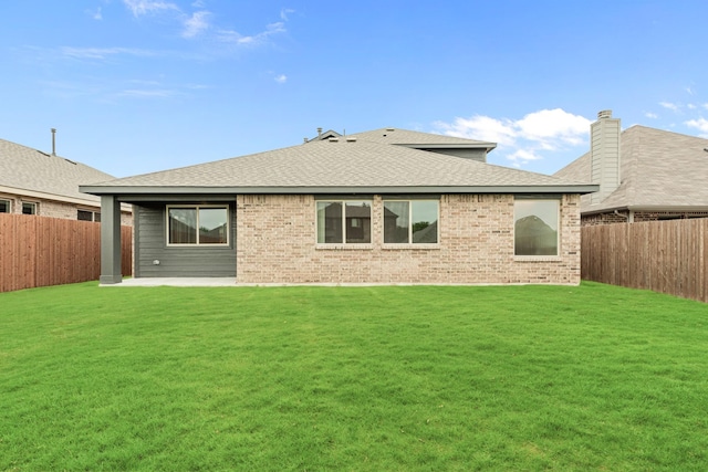 back of house featuring a lawn