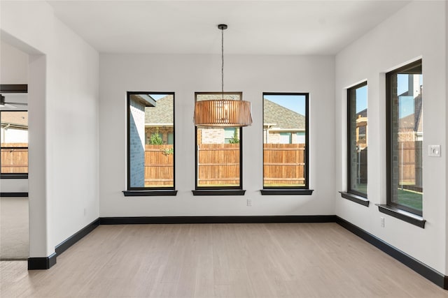 unfurnished dining area featuring plenty of natural light and light hardwood / wood-style floors