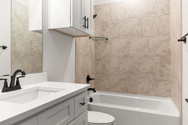 full bathroom featuring tiled shower / bath, vanity, and toilet