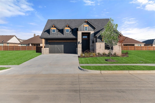 view of front of property featuring a front yard and a garage