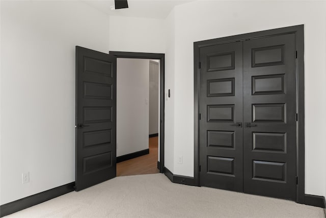 carpeted bedroom featuring a closet